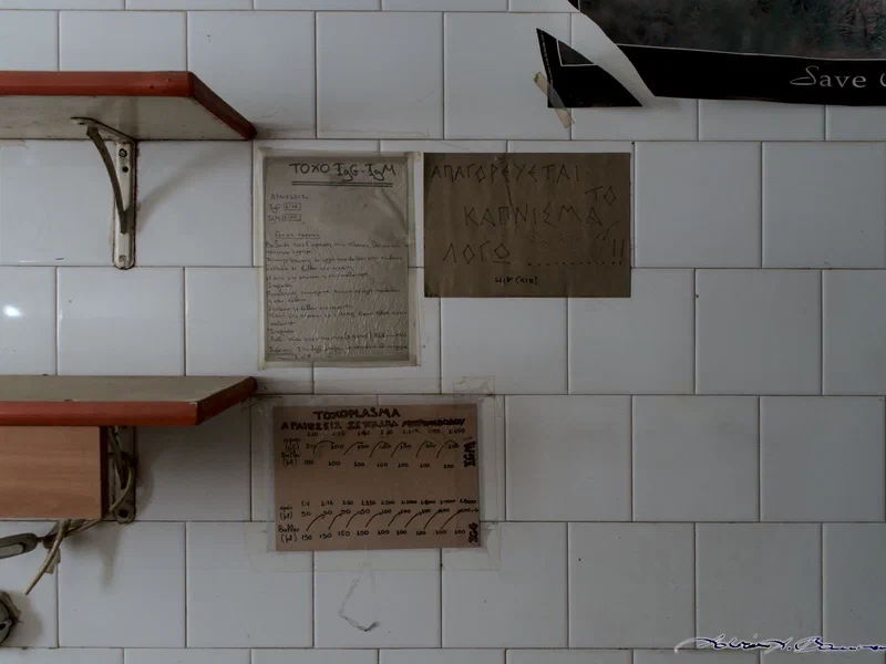 The notes on how to measure blood toxins are still up — next to a handwritten passive-aggressive no-smoking-sign. Every sign, they say, has a history...