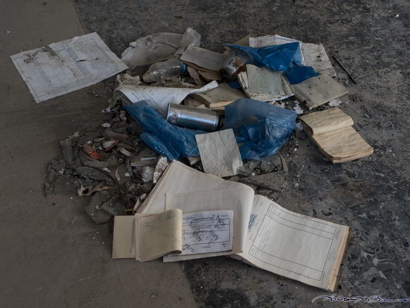 Several rooms in the hospital look like somebody actually swept them recently. This room — the old pharmacy, by the looks of it — had prescriptions and export bills for pharmaceuticals in a pile on the floor.